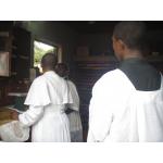 The Sacristian tells the priest about the Mass of the Sunday.jpg